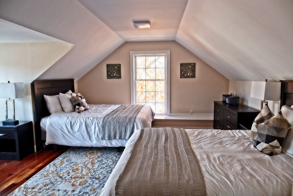 Bedroom with two beds and window